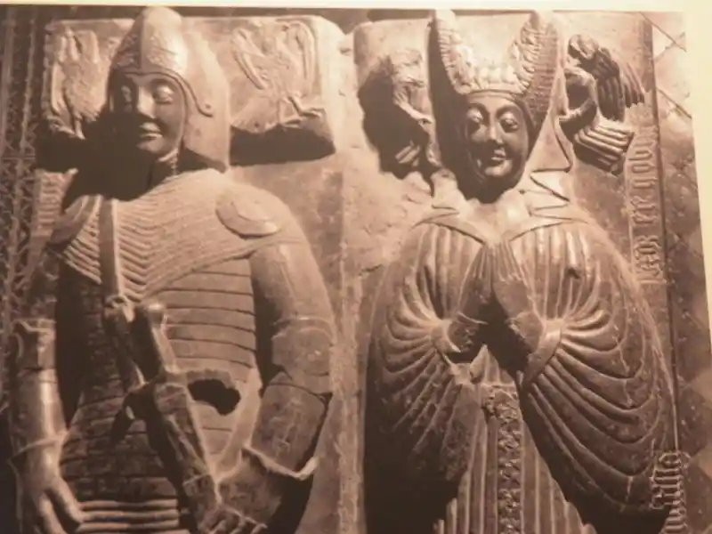 Horn-like headwear of a priest-like person on a carved slab